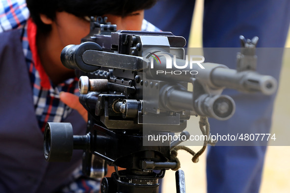 Indian school students take a close look at the various defence equipment during an exhibition organised by the Indian Army in Ajmer, Rajast...