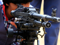 Indian school students take a close look at the various defence equipment during an exhibition organised by the Indian Army in Ajmer, Rajast...