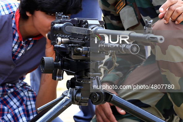 Indian school students take a close look at the various defence equipment during an exhibition organised by the Indian Army in Ajmer, Rajast...