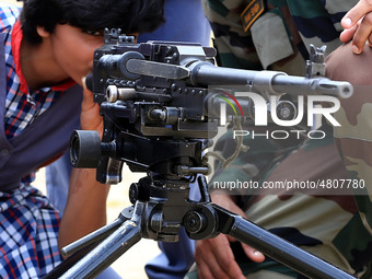 Indian school students take a close look at the various defence equipment during an exhibition organised by the Indian Army in Ajmer, Rajast...