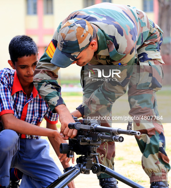 Indian school students take a close look at the various defence equipment during an exhibition organised by the Indian Army in Ajmer, Rajast...