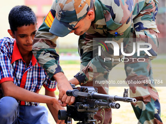 Indian school students take a close look at the various defence equipment during an exhibition organised by the Indian Army in Ajmer, Rajast...