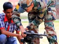 Indian school students take a close look at the various defence equipment during an exhibition organised by the Indian Army in Ajmer, Rajast...