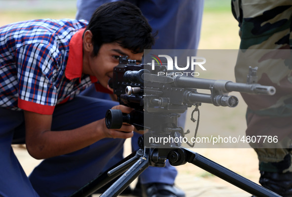 Indian school students take a close look at the various defence equipment during an exhibition organised by the Indian Army in Ajmer, Rajast...