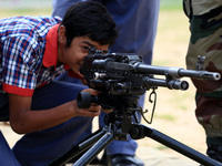 Indian school students take a close look at the various defence equipment during an exhibition organised by the Indian Army in Ajmer, Rajast...