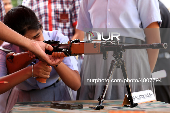 Indian school students take a close look at the various defence equipment during an exhibition organised by the Indian Army in Ajmer, Rajast...