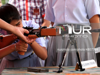 Indian school students take a close look at the various defence equipment during an exhibition organised by the Indian Army in Ajmer, Rajast...