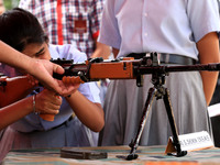 Indian school students take a close look at the various defence equipment during an exhibition organised by the Indian Army in Ajmer, Rajast...