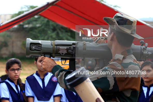 Indian school students take a close look at the various defence equipment during an exhibition organised by the Indian Army in Ajmer, Rajast...