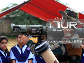 Indian school students take a close look at the various defence equipment during an exhibition organised by the Indian Army in Ajmer, Rajast...