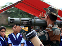 Indian school students take a close look at the various defence equipment during an exhibition organised by the Indian Army in Ajmer, Rajast...