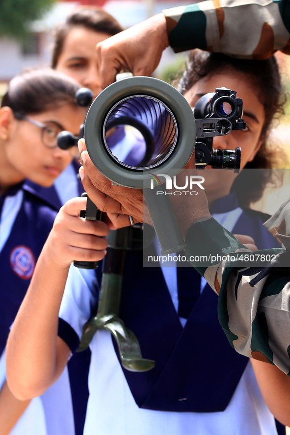 Indian school students take a close look at the various defence equipment during an exhibition organised by the Indian Army in Ajmer, Rajast...