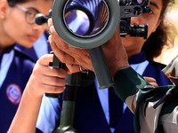 Indian school students take a close look at the various defence equipment during an exhibition organised by the Indian Army in Ajmer, Rajast...