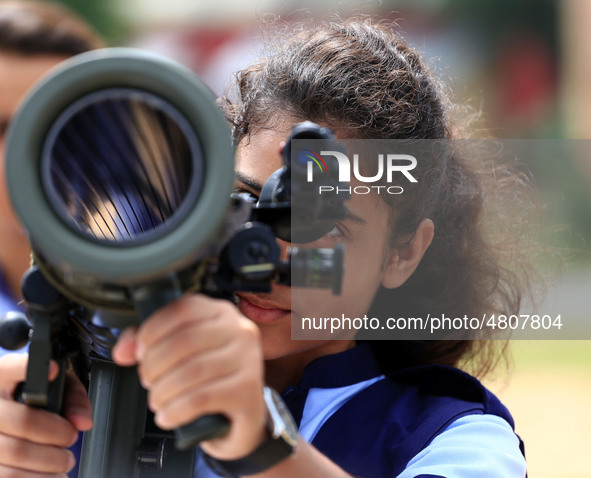 Indian school students take a close look at the various defence equipment during an exhibition organised by the Indian Army in Ajmer, Rajast...