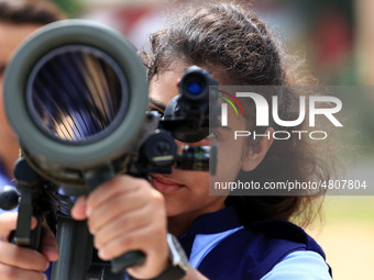 Indian school students take a close look at the various defence equipment during an exhibition organised by the Indian Army in Ajmer, Rajast...