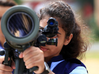 Indian school students take a close look at the various defence equipment during an exhibition organised by the Indian Army in Ajmer, Rajast...