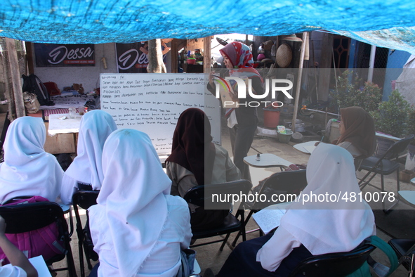 Cijeruk 1 Junior High School students openly study in the yard of a resident's house with a tarpaulin roof in Palasari Village, Bogor Regenc...