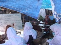 Cijeruk 1 Junior High School students openly study in the yard of a resident's house with a tarpaulin roof in Palasari Village, Bogor Regenc...