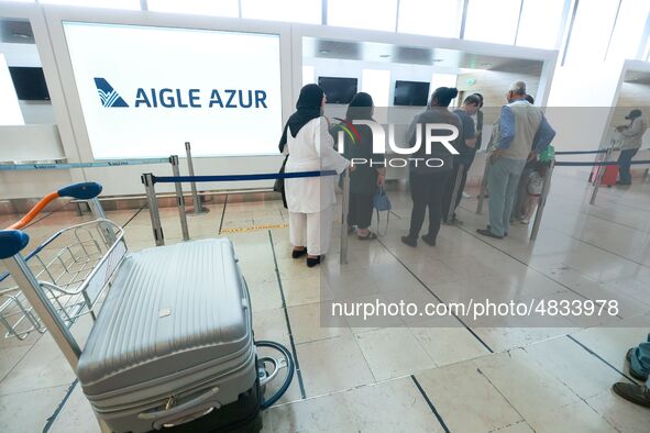 Passengers wait in front of the French airline Aigle Azur’s reception desk, without any employees, at Orly airport, France  on September 6,...