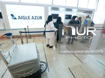 Passengers wait in front of the French airline Aigle Azur’s reception desk, without any employees, at Orly airport, France  on September 6,...