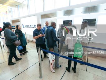 Passengers wait in front of the French airline Aigle Azur’s reception desk, without any employees, at Orly airport, France  on September 6,...