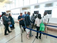 Passengers wait in front of the French airline Aigle Azur’s reception desk, without any employees, at Orly airport, France  on September 6,...