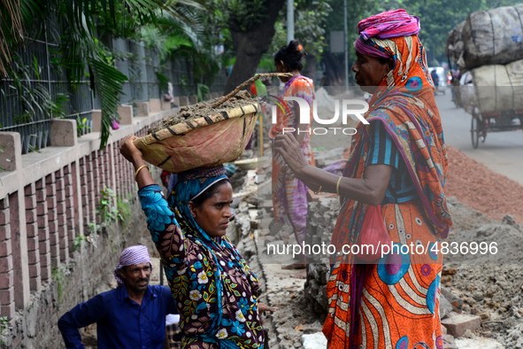 Bangladeshi women day laborer works in a road construction site in Dhaka, Bangladesh, on September 7, 2019. 