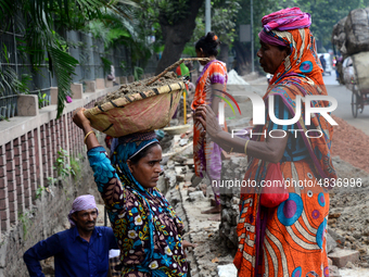 Bangladeshi women day laborer works in a road construction site in Dhaka, Bangladesh, on September 7, 2019. (