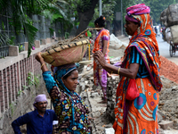 Bangladeshi women day laborer works in a road construction site in Dhaka, Bangladesh, on September 7, 2019. (