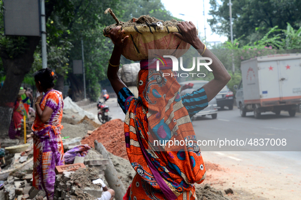 Bangladeshi women day laborer works in a road construction site in Dhaka, Bangladesh, on September 7, 2019. 