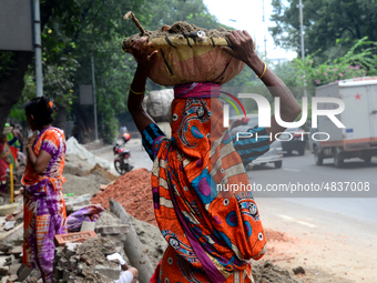 Bangladeshi women day laborer works in a road construction site in Dhaka, Bangladesh, on September 7, 2019. (