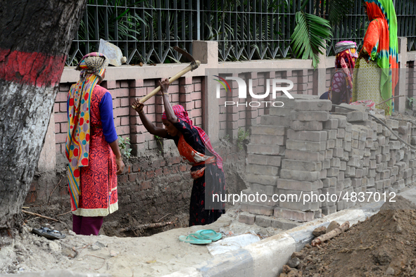 Bangladeshi women day laborer works in a road construction site in Dhaka, Bangladesh, on September 7, 2019. 