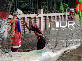 Bangladeshi women day laborer works in a road construction site in Dhaka, Bangladesh, on September 7, 2019. (