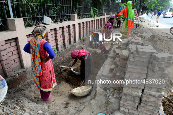 Bangladeshi women day laborer works in a road construction site in Dhaka, Bangladesh, on September 7, 2019. 