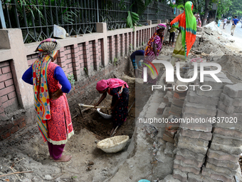 Bangladeshi women day laborer works in a road construction site in Dhaka, Bangladesh, on September 7, 2019. (