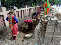 Bangladeshi women day laborer works in a road construction site in Dhaka, Bangladesh, on September 7, 2019. (