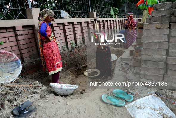 Bangladeshi women day laborer works in a road construction site in Dhaka, Bangladesh, on September 7, 2019. 