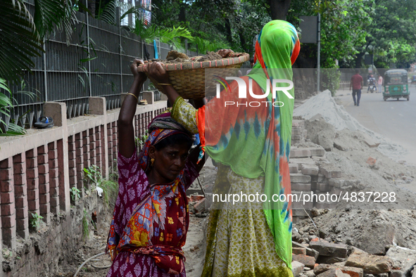 Bangladeshi women day laborer works in a road construction site in Dhaka, Bangladesh, on September 7, 2019. 