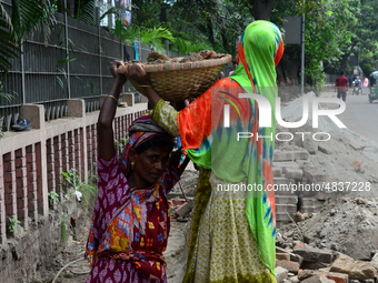 Bangladeshi women day laborer works in a road construction site in Dhaka, Bangladesh, on September 7, 2019. (