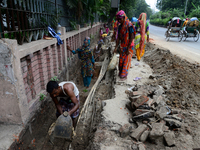 Bangladeshi men and women day laborer works in a road construction site in Dhaka, Bangladesh, on September 7, 2019. (