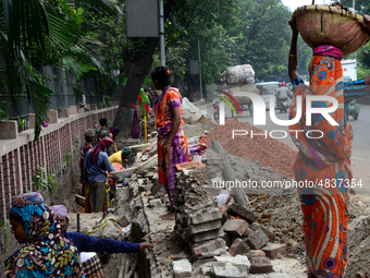 Bangladeshi men and women day laborer works in a road construction site in Dhaka, Bangladesh, on September 7, 2019. (