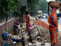 Bangladeshi men and women day laborer works in a road construction site in Dhaka, Bangladesh, on September 7, 2019. (