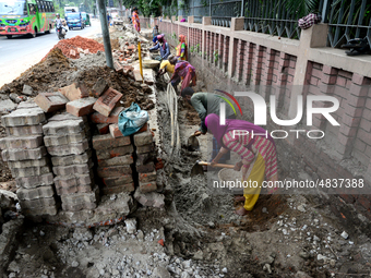 Bangladeshi men and women day laborer works in a road construction site in Dhaka, Bangladesh, on September 7, 2019. (