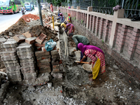 Bangladeshi men and women day laborer works in a road construction site in Dhaka, Bangladesh, on September 7, 2019. (