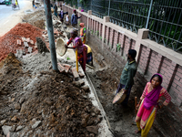 Bangladeshi men and women day laborer works in a road construction site in Dhaka, Bangladesh, on September 7, 2019. (