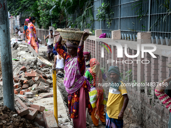 Bangladeshi men and women day laborer works in a road construction site in Dhaka, Bangladesh, on September 7, 2019. (