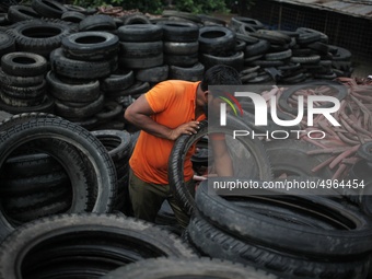 Workers seen handling pieces of old tyres to be recycled in Dhaka,  Bangladesh on 07 October 2019. (