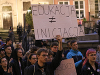 Protester holding sign that says 'Educations is not a (sexual) initiation' during the rally against a bill that would criminalize sex educat...
