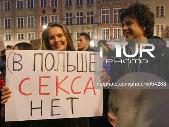 Protester holding sign that says in Russian 'In Poland there is no sex'  during the rally against a bill that would criminalize sex educatio...