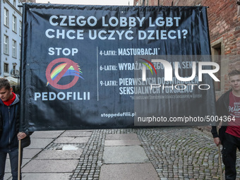 Protester holding sign that says 'Stop Pedophilia, What LGBT lobby wants to teach our children'  during the rally against a sexual education...